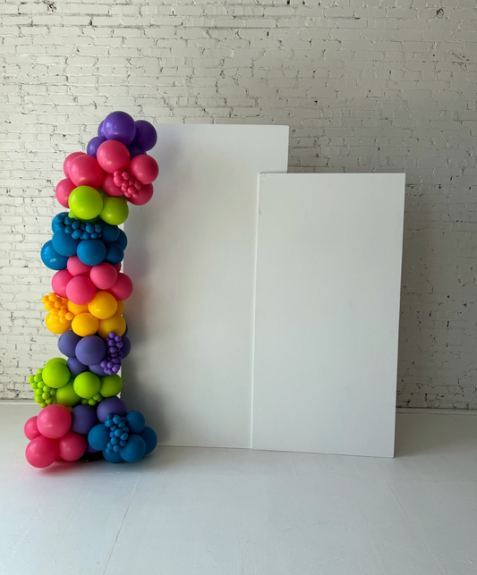 White rectangular backdrop panel rental styled with colorful balloon décor by Lady With The Balloons in Leawood, Kansas — elegant and versatile event backdrop design.